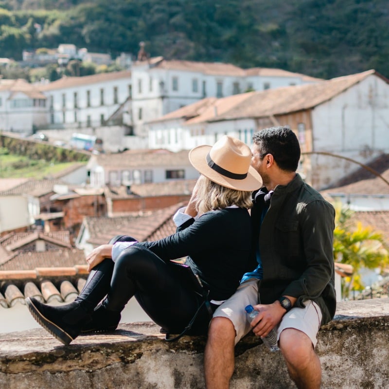 Tourist couple admiring the historic city of Ouro Preto, Minas Gerais, Brazil