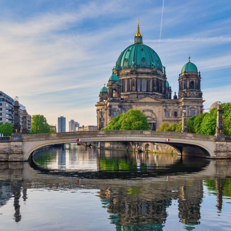 Buildings and bridges cast a reflection on the water in Berlin, Germany