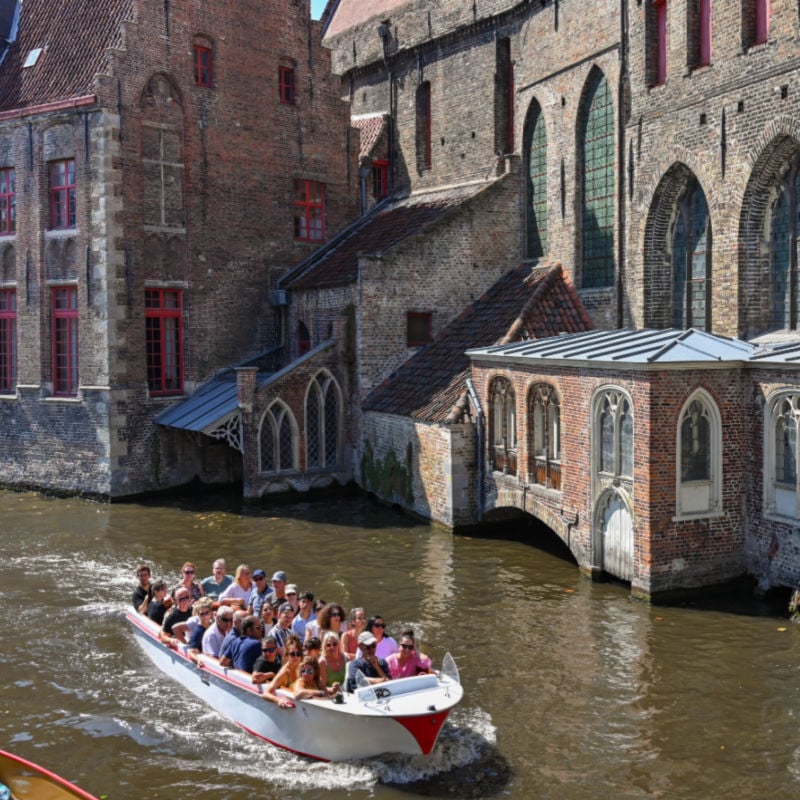 group of tourists in a boat that travels the canal system of the city