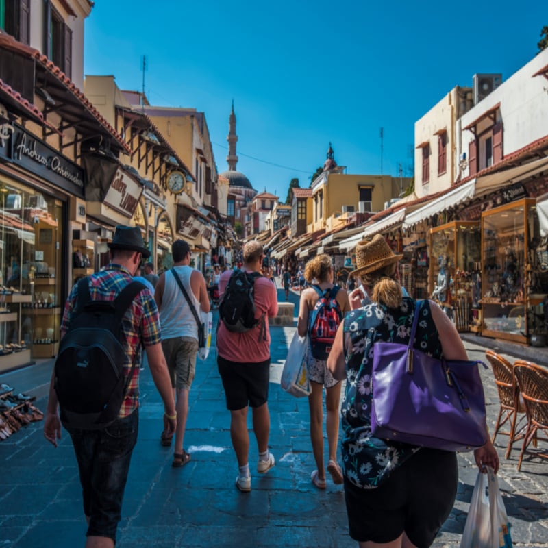 Tourists exploring the medieval streets of the old town of Rhodes