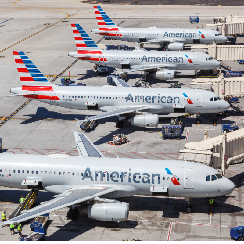 A row of American Airlines planes at an airport 