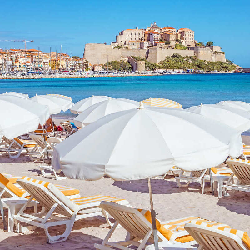 A beach full of sun loungers in Corsica, France. 