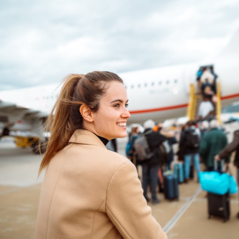 Happy woman boarding a plane