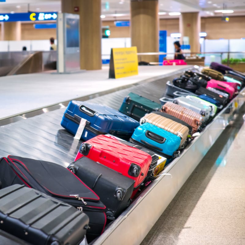 airport checked baggage carousel with a lot of luggage
