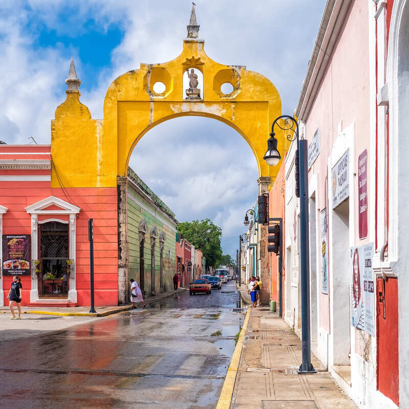 Yellow Colonial Arch In Merida, A Colonial Era City In The Yucatan Peninsula Of Mexico