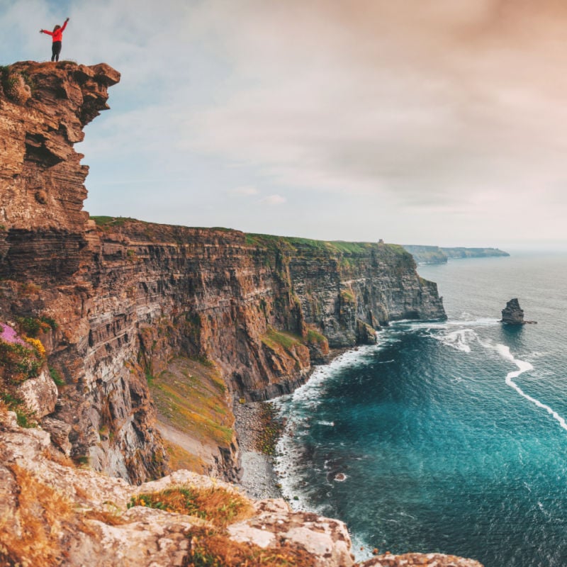 Woman or solo traveler on the Cliffs of Moher in Ireland
