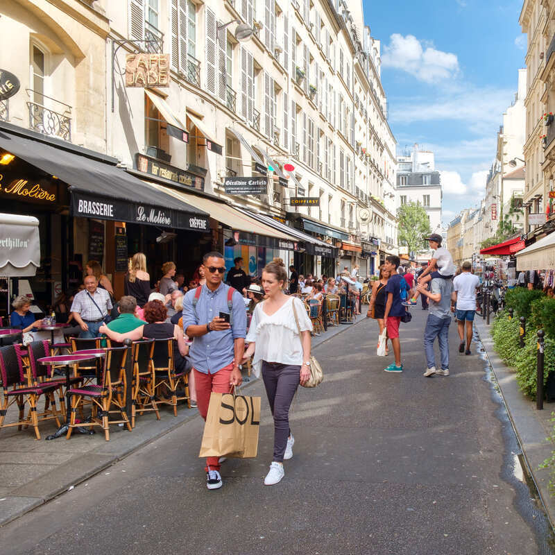Tourists walking down a street lined with restaurants in the Latin Quarter, Paris, France, Europe