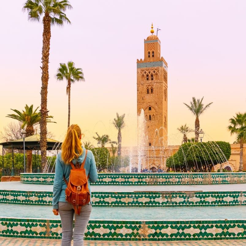 woman looking at mosque in morocco