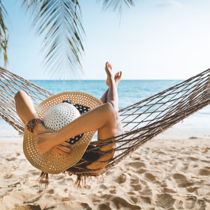 solo traveler on beach hammock