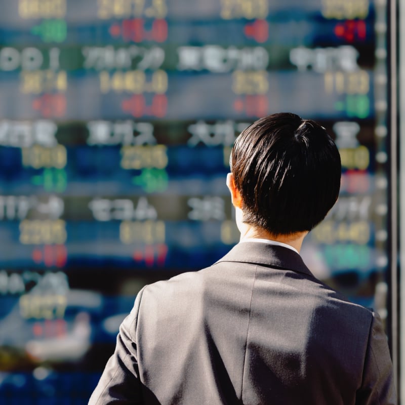 Man looking at a stock board in Tokyo Japan