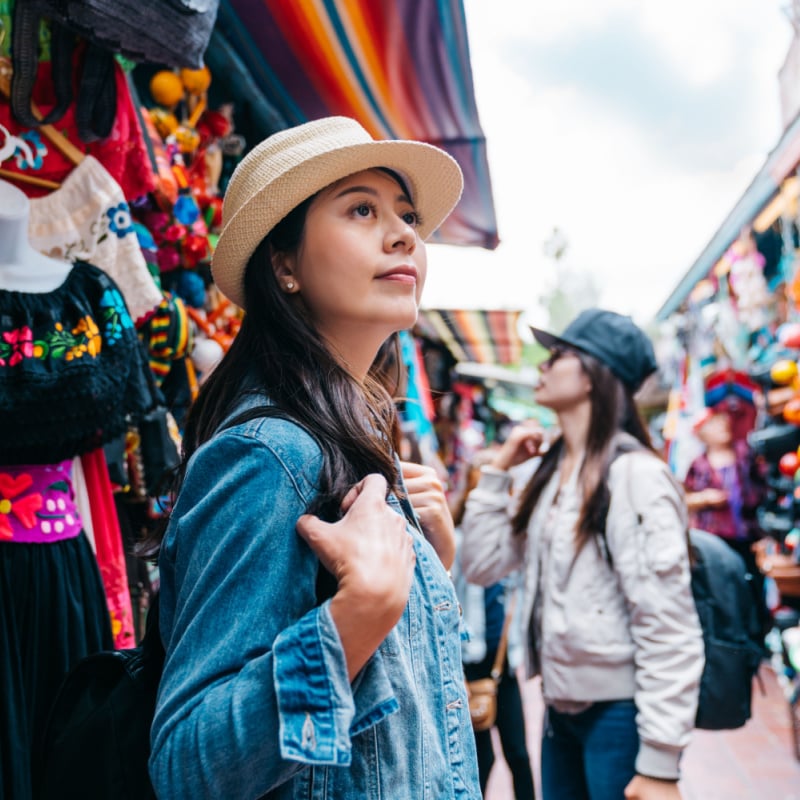 A tourist wishes she spoke more Spanish as she looks around a market in Mexico