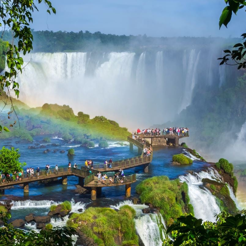 Puerto Iguazu Falls with tourists on a boardwalk overlooking the falls