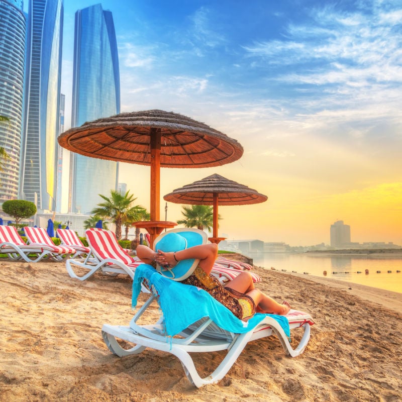 Tourist Relaxing On A Beach In Dubai, United Arab Emirates