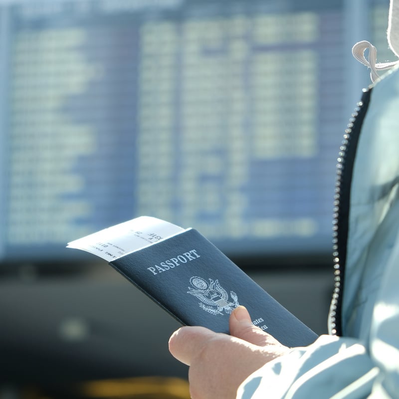 traveler holding United States passport at airport